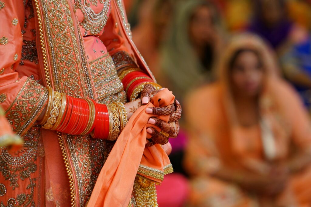 Close-up of a bride in a traditional Indian wedding, showcasing exquisite henna and jewelry.